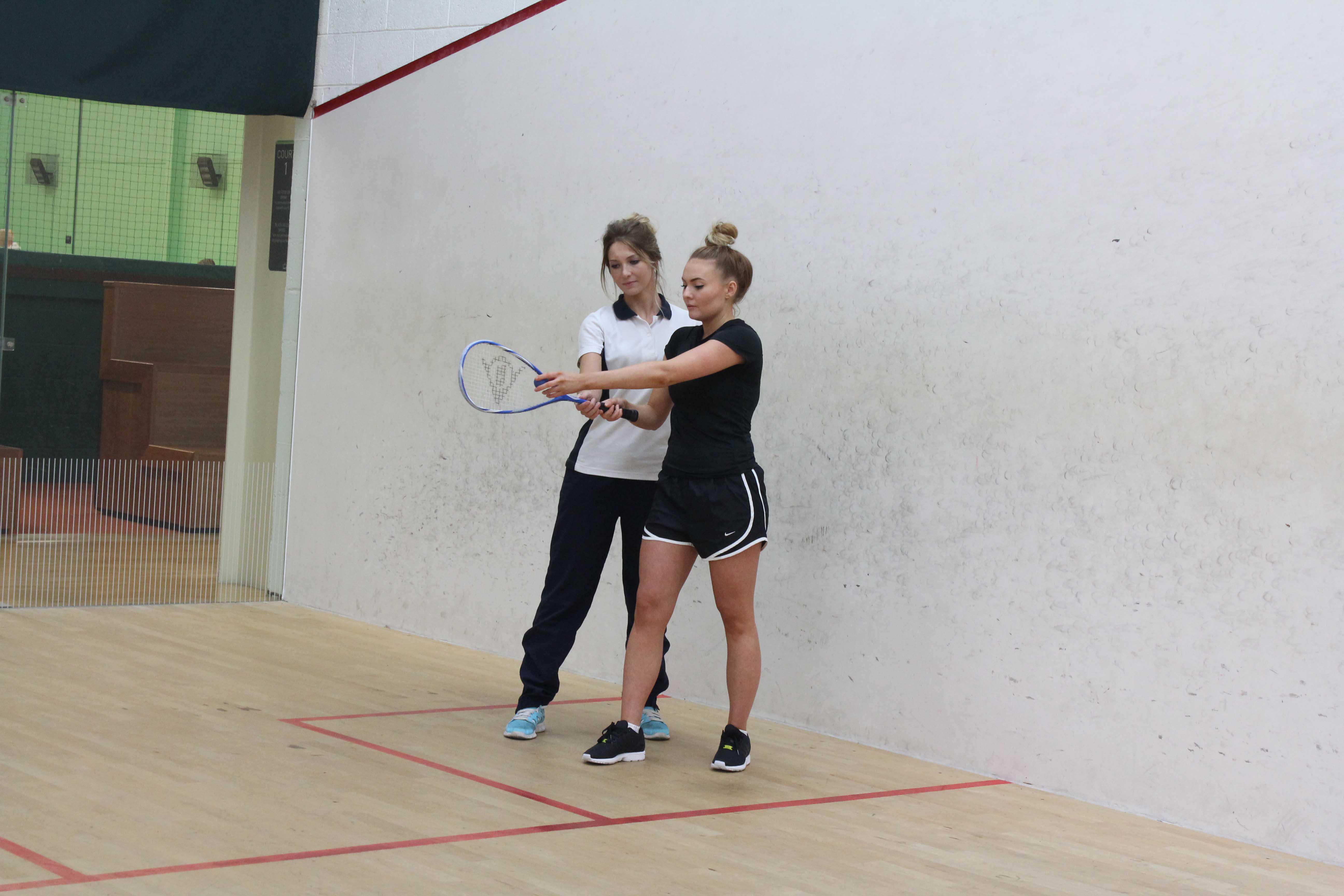 One of our therapists helping her patient return to sport by ensuring she has re-gained her range of motion during squash.