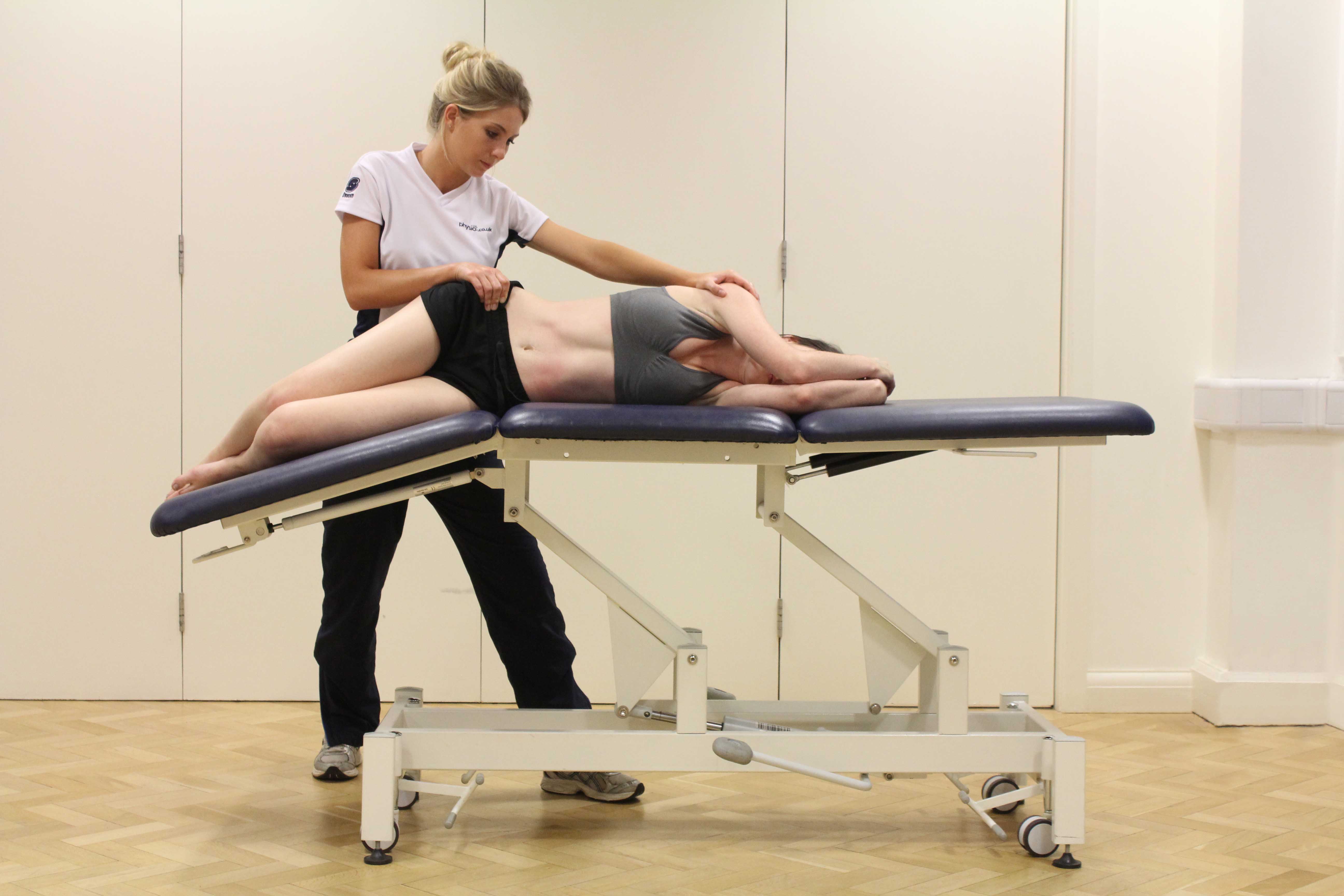 Passive stretch of the muscles and connective tissues of the hip and pelvis by specialist therapist