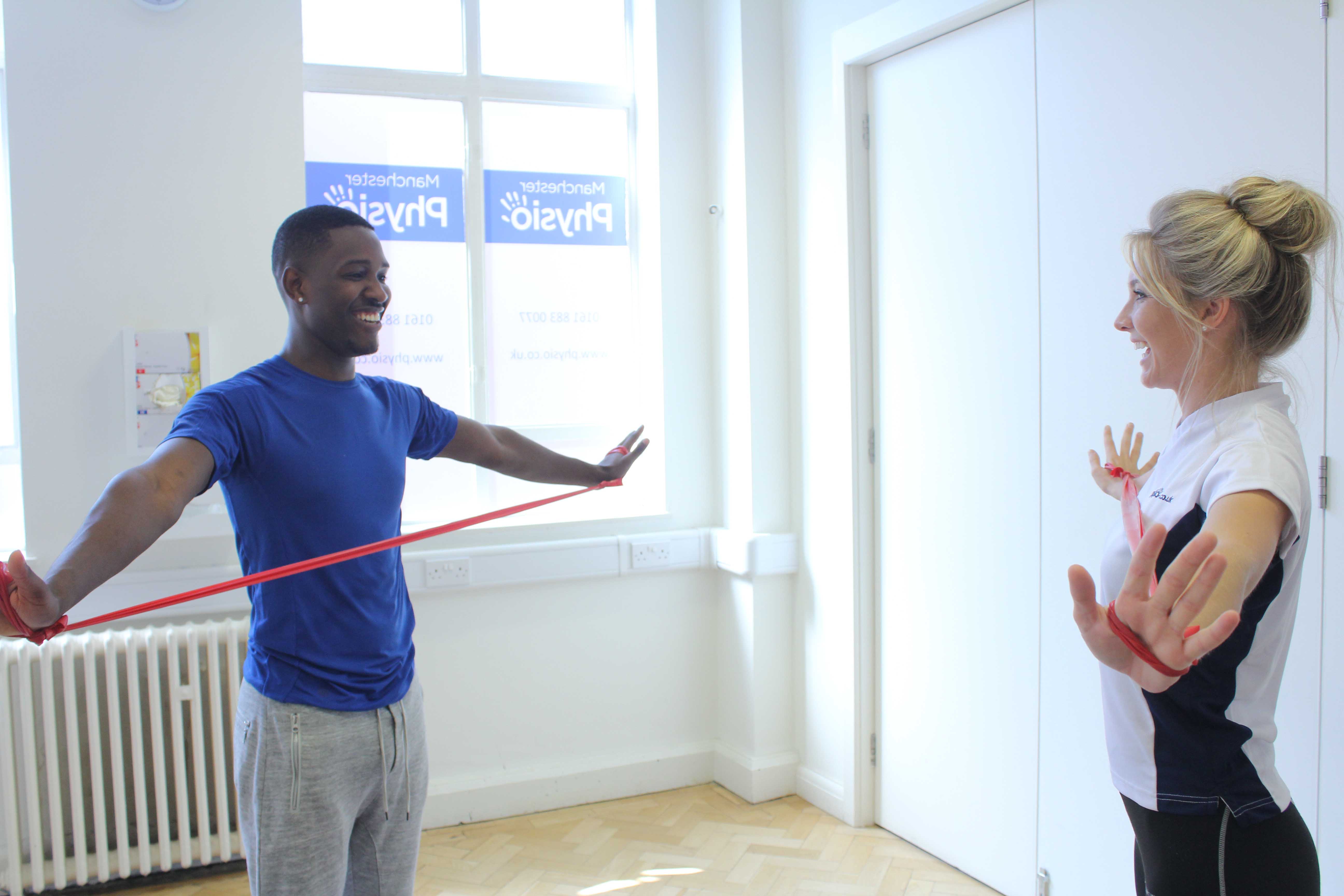 One of our clients strengthening the shoulder capsule with our therapist.