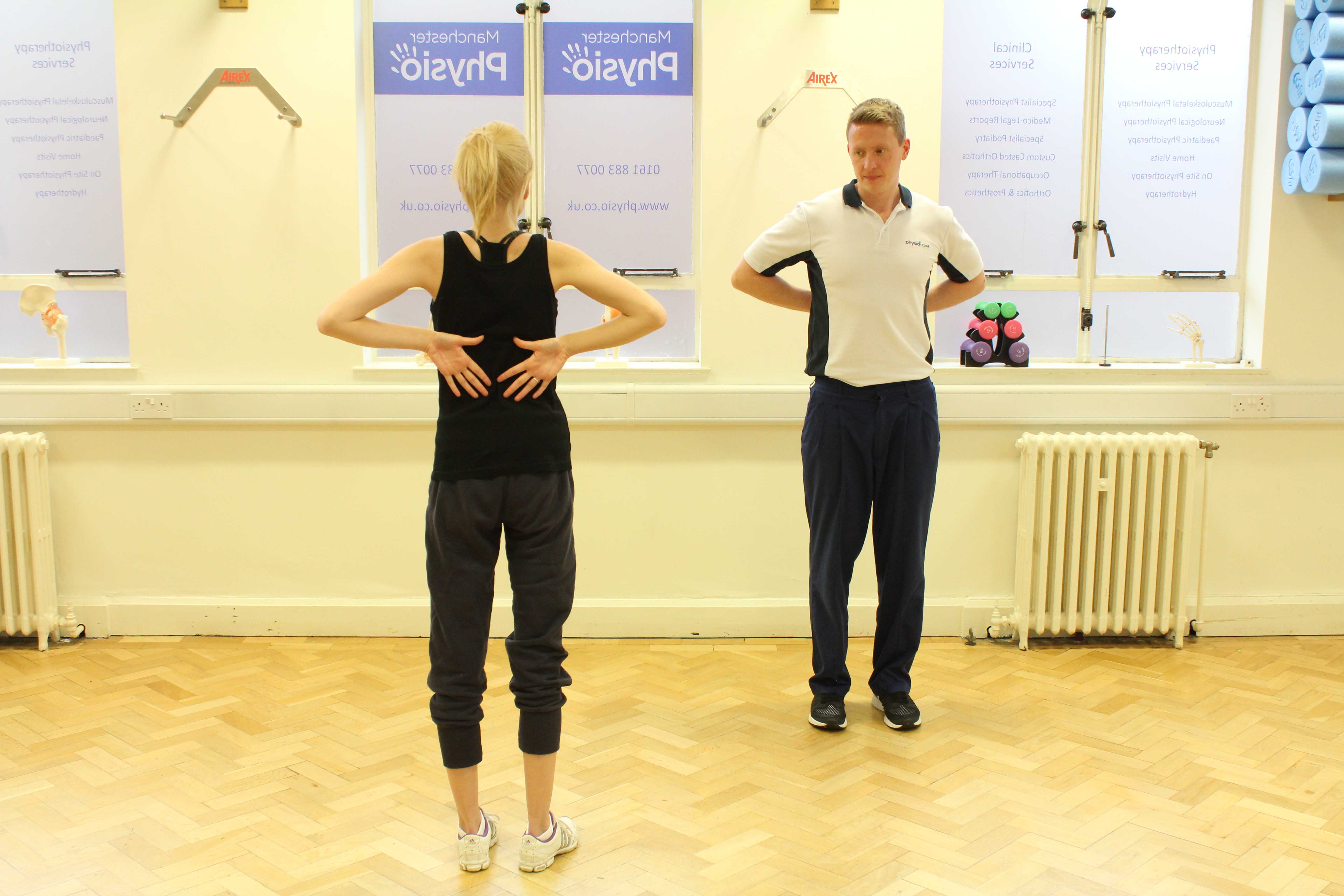 Physiotherapist testing his patients range of motion in the shoulder joint